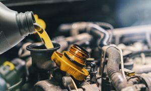 Pouring oil to car engine. Fresh oil poured during an oil change to a car | Temple Hills, MD