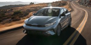a gray green 2024 Kia Forte driving down a country road | Temple Hills, MD