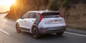 a white 2024 Kia Niro EV rear view driving down a hilly road | Temple Hills, MD